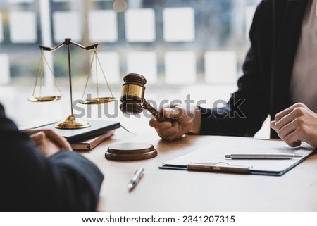 Lawyer is explaining the terms of the legal contract document and asking the client to sign it properly. Legal counsel and legal proceedings consulting services. Royalty-Free Stock Photo #2341207315