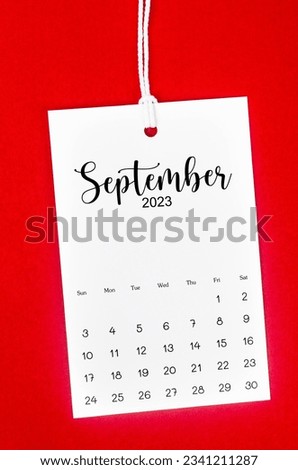September 2023 calendar page for 2023 year hanged on white rope on Red background. Royalty-Free Stock Photo #2341211287