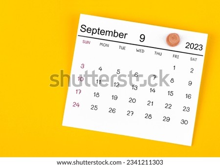 September 2023 and wooden push pin on yellow background. Royalty-Free Stock Photo #2341211303