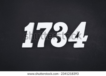 Black for the background. The number 1734 is made of white painted wood.