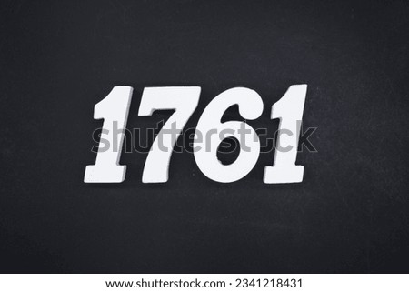 Black for the background. The number 1761 is made of white painted wood.