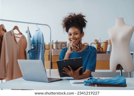 Pretty African American sme business woman working Custom Ecommerce Packaging leading supplier of custom packaging. create a personalised experience, fast production and competitive pricing Royalty-Free Stock Photo #2341219227