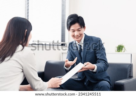 Salesman presenting documents with a smile