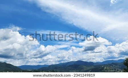 A breathtaking and fantastic picture drawn by nature on a bright sunny day. The sky is adorned with a breathtaking display of different types of clouds weaving together mesmerizing tapestry of beauty.