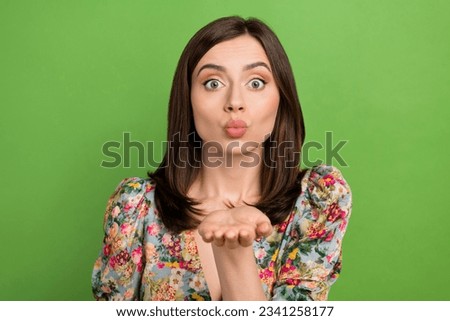 Photo of stunning lovely lady pouted lips arm palm send air kiss you isolated on green color background