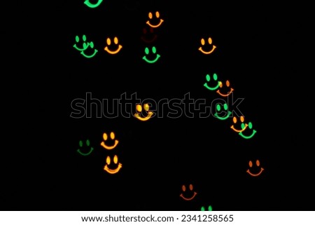 Garland with bokeh smiles shape flickering on the black background.