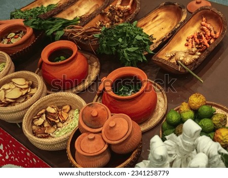 Various Herbs and spices in wooden bowls, weaving basket, clay pot, Thai Herbal Ball, ingredients used in herbal folk medicine,Herbs for aromatherapy or Thai massage, alternative medicine Royalty-Free Stock Photo #2341258779