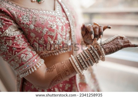 Indian Bride Showing off her Bangles.  Royalty-Free Stock Photo #2341258935