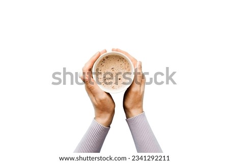 Minimalistic style woman hand holding a cup of coffee on Colored background. Flat lay, top view cappuccino cup. Empty place for text, copy space. Coffee addiction. Top view, flat lay. Royalty-Free Stock Photo #2341292211
