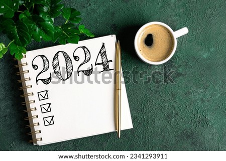 New year resolutions 2024 on desk. 2024 resolutions list with notebook, coffee cup on table. Goals, resolutions, plan, action, checklist concept. New Year 2024 template, copy space Royalty-Free Stock Photo #2341293911