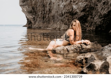 Woman travel sea. Happy tourist enjoy taking picture outdoors for memories. Woman traveler swim in the sea bay with mountains, sharing travel adventure journey
