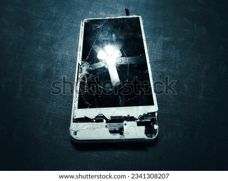 This smartphone is broken. Devices are lost. The broken screen has a reflection of the lamp, looks beautiful. Smartphones are an ever-evolving technology.