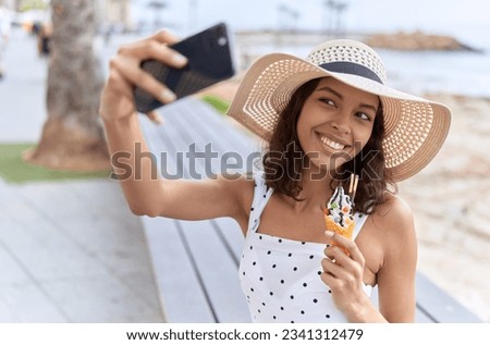 Young african american woman tourist make selfie by smartphone eating ice cream at seaside