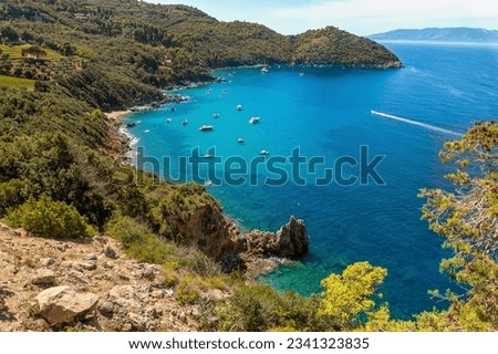 Beautiful mediterranean italian landscape. Aerial view from the panoramic road of the commune of Monte Argentario to the beach of Cala grande. Turquoise water of the Tyrrhenian Sea. Tuscany, Grosseto.