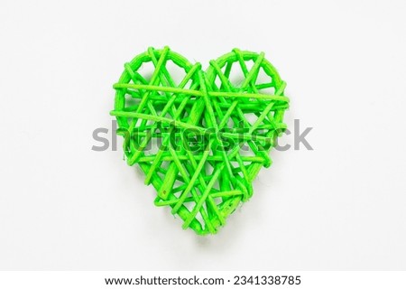 Wooden wicker heart. Rattan work in the shape of a heart. Love concept. Background with selective focus and copy space. Light back