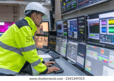 Engineer working at control room,Manager control system,Technician man monitoring program from a lot of monitor Royalty-Free Stock Photo #2341349315