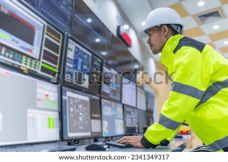 Engineer working at control room,Manager control system,Technician man monitoring program from a lot of monitor Royalty-Free Stock Photo #2341349317