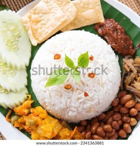 Nasi lemak, a traditional malay curry paste rice dish served on a banana leaf