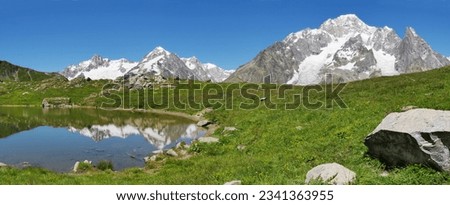 The south face of Mont Blanc -italian side-, from the Vesses lake in Val Veny valley along the famous Tour du Mont Blanc trail. Courmayer, Valle d-Aosta, Italy.