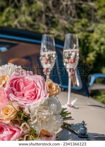 Bride and groom, wedding dress, bridal bouquet and champagne, wedding rings and accessories, a wedding cake