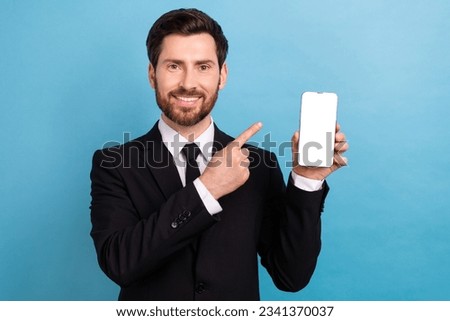 Photo of young business broker agency owner man formalwear direct finger empty space web page phone isolated on blue color background