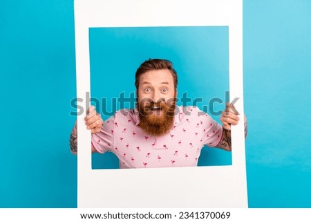 Portrait of impressed overjoyed person hands hold paper album set card window isolated on blue color background