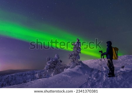 "The photographer" Northern lights (Aurora Borealis) in the mountains of Kandalaksha, Murmansk region, Russia, Far North, Polar Night