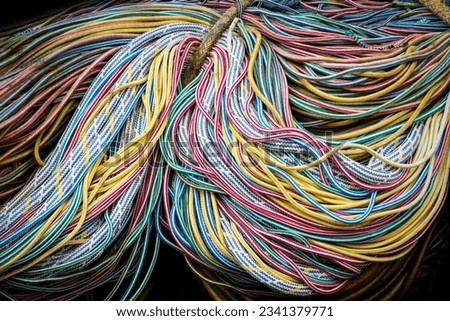 Mass picture of bunch of colorful nautical marine rope bound together, habour equipment, abstract background formed of ropes. 