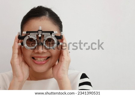 Woman wearing eyeglasses visual acuity test with test chart, eye test, Female patient checking eyesight in ophthalmology clinic, eye check, girl eye test