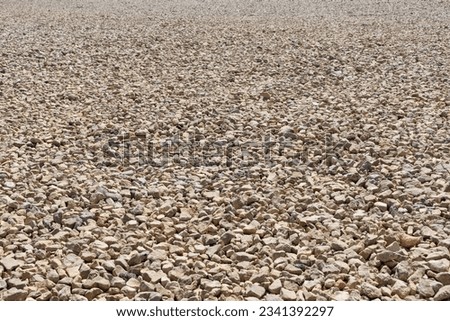 Background of crushed stones in perspective. Granite stones, small stone chips, building material rock, gravel texture. Royalty-Free Stock Photo #2341392297