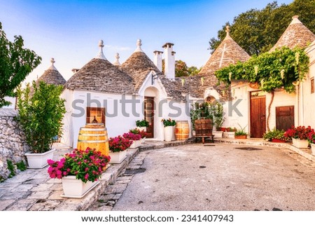 Famous Trulli Houses during a Sunny Day with Bright Blue Sky in Alberobello, Puglia, Italy Royalty-Free Stock Photo #2341407943