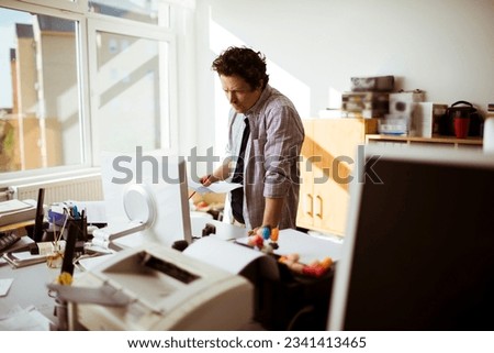 Young caucasian man working in a press office