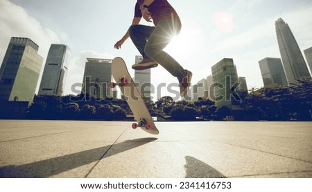 Asian woman skateboarder skateboarding in modern city Royalty-Free Stock Photo #2341416753