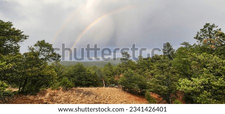 A scenic view of a double rainbow in Santa Fe, New Mexico.