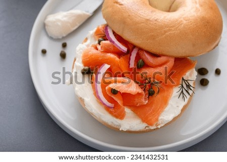 Plain bagel with salmon and cream cheese with fresh dill and capers for breakfast Royalty-Free Stock Photo #2341432531