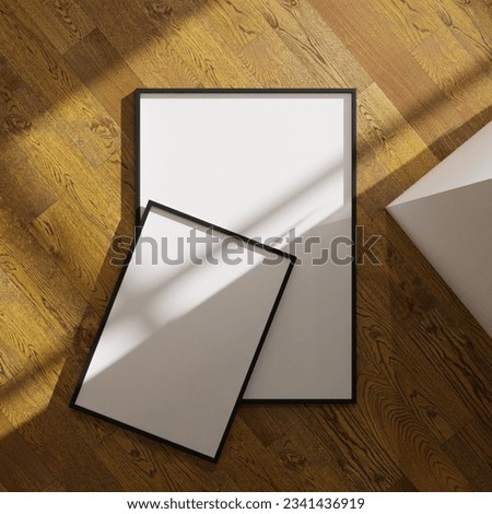 set of two with duifferent size aesthetic frame mockup poster laying on the wooden floor lit by sunlight. 50x70, 20x28, 20RP frame mockup poster. 70x100 frame mockup poster Royalty-Free Stock Photo #2341436919