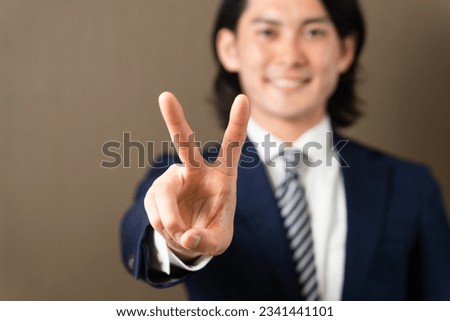 
Business image of a young man doing a peace sign