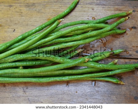 Fresh long beans on a wooden board