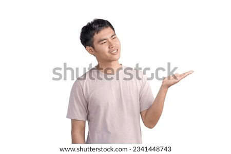 Young handsome man wearing a casual t-shirt standing over white background approving doing positive gestures with his hand, presenting and showing with hands, smilling and happy for success.
