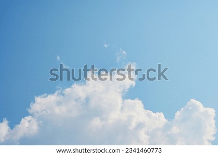 beautiful blue sky and white fluffy cloud with sunrise in the morning, natural background
