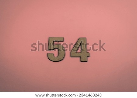 Number 54 in wood on a pink background