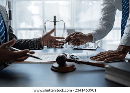 Attorneys or lawyer reading statute of limitations, consulting between male lawyers and business clients, tax firms and examining contract documents in business before signing Royalty-Free Stock Photo #2341463901
