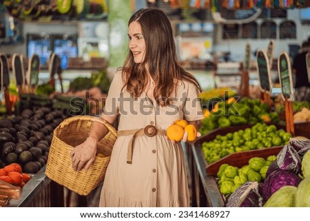 A glowing pregnant woman after forty makes a healthy choice as she selects organic vegetables and fruits at the vibrant organic market, prioritizing her well-being and her baby's health Royalty-Free Stock Photo #2341468927