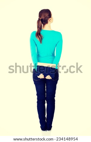 Back view of young student woman holding an old book. Isolated over white background.