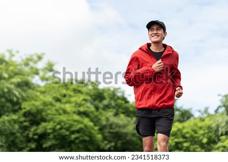 Attractive Young indian man wearing sportswear running on track at sport stadium. Asian Fit man jogging outdoor cross the finish line. Exercise in the morning. Healthy and active lifestyle concept. Royalty-Free Stock Photo #2341518373