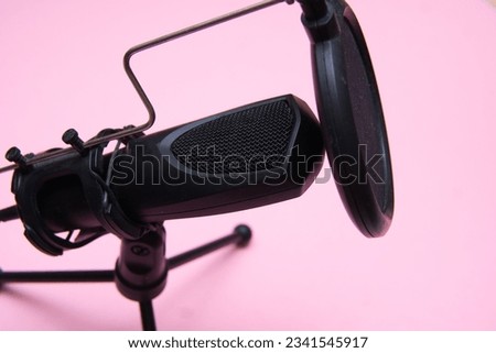 microphone on a pink background. Recording a podcast in a home studio