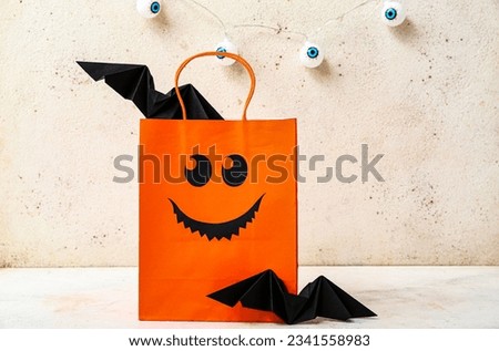 Composition with shopping bag and bats for Halloween on light background