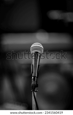 A microphone sitting alone on its stand Royalty-Free Stock Photo #2341560419