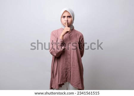 Ssshh of South East Asian Indonesian Malay Hijab Girl for Shut up or Whisper to Silence Royalty-Free Stock Photo #2341561515