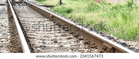 a photography of a train track with a train on it, there is a train track that has a train on it.